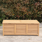A rectangular wooden storage bench sits outdoors on a concrete surface in front of a dense green and reddish-brown hedge.