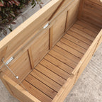 A wooden garden storage bin with a slatted wooden base and a clear plastic lid supported by metal hinges and cables, shown outdoors on a concrete surface.