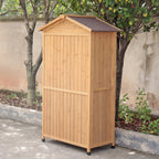 The reverse of a wooden outdoor storage shed with a slanted roof in an outdoor setting.