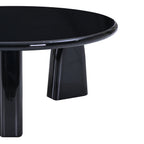 Close-up of the Design Republique black lacquer coffee table showing the glossy round edge and leg detail.