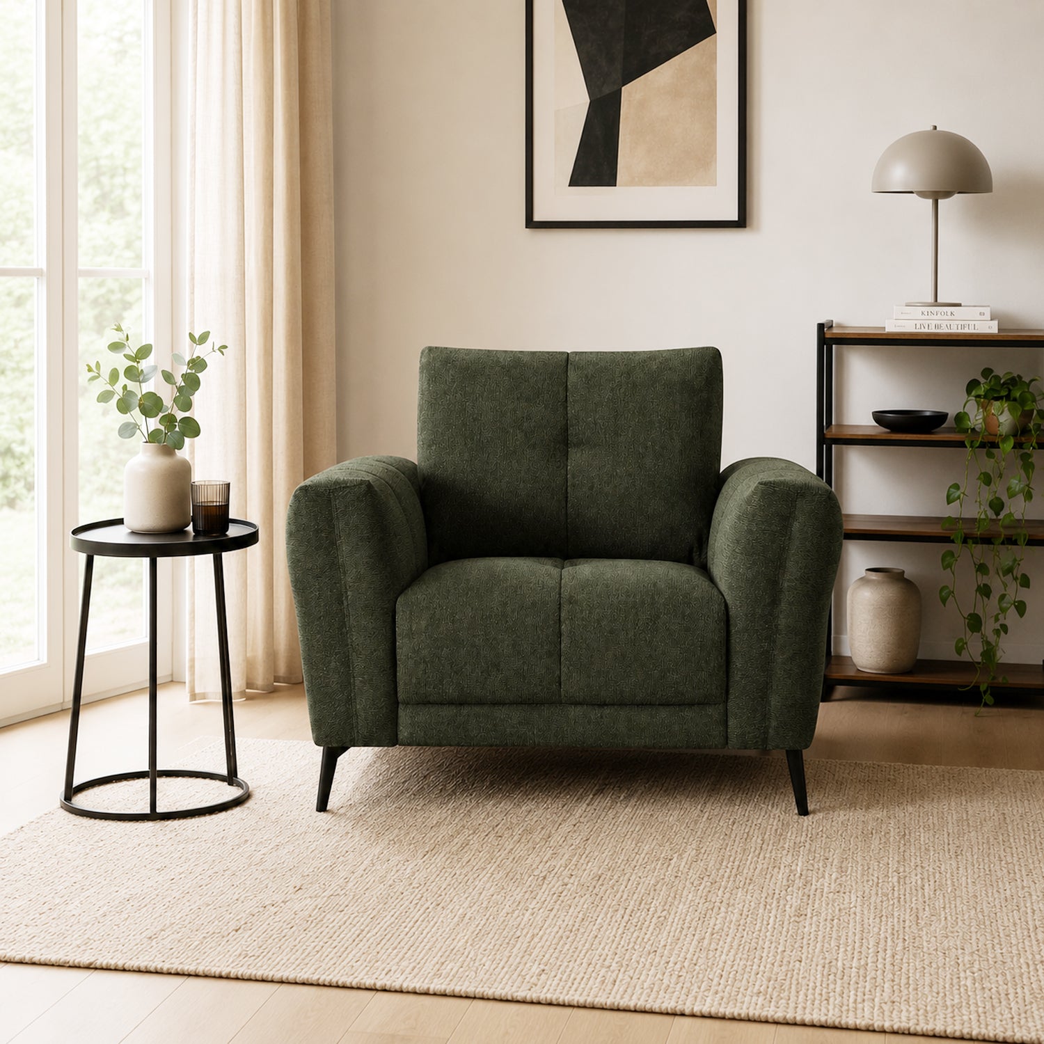 Design Republique Nado armchair in moss styled in a neutral living room with a side table and shelving.