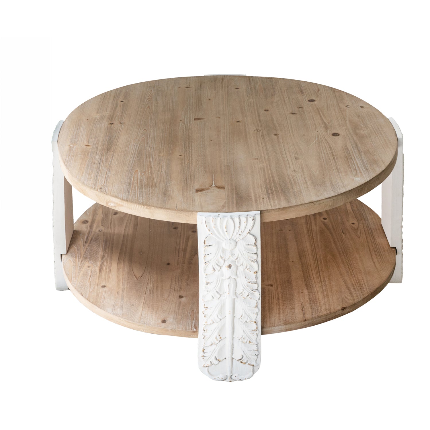 Round natural wood coffee table with a lower shelf and carved antique white legs featuring decorative floral detailing.