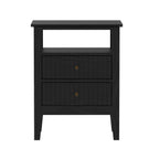 A black wooden nightstand or side table with an open shelf on top and two vertically paneled drawers below is shown against a plain light background.