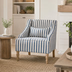 A blue and white striped accent armchair with turned wooden legs brings timeless coastal charm to a bright modern country living space.