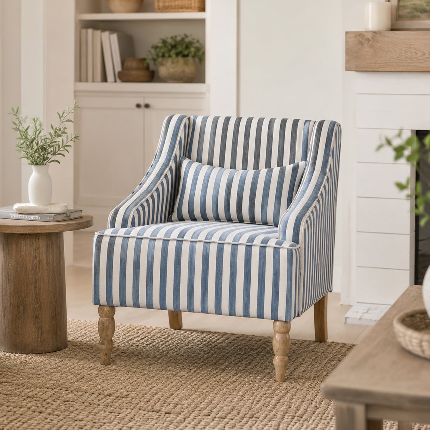 A blue and white striped accent armchair with turned wooden legs brings timeless coastal charm to a bright modern country living space.