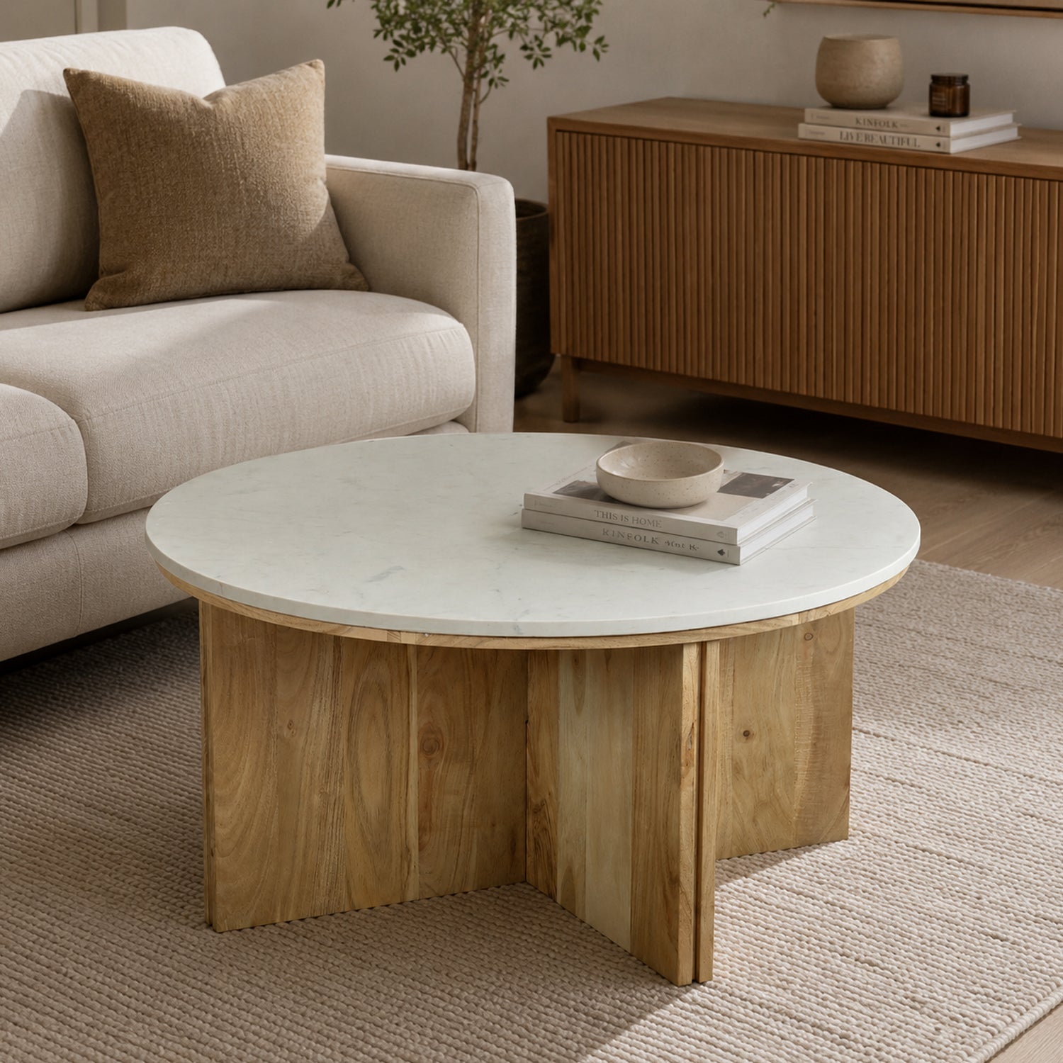Design Republique Sara marble coffee table styled in a neutral living room with décor on top.