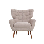 Natural upholstered armchair with a button-tufted wingback design, wide cushioned seat, supportive armrests and tapered wooden legs.