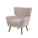 Natural upholstered armchair featuring a button-tufted wingback backrest, generously cushioned seat, curved armrests and tapered wooden legs.