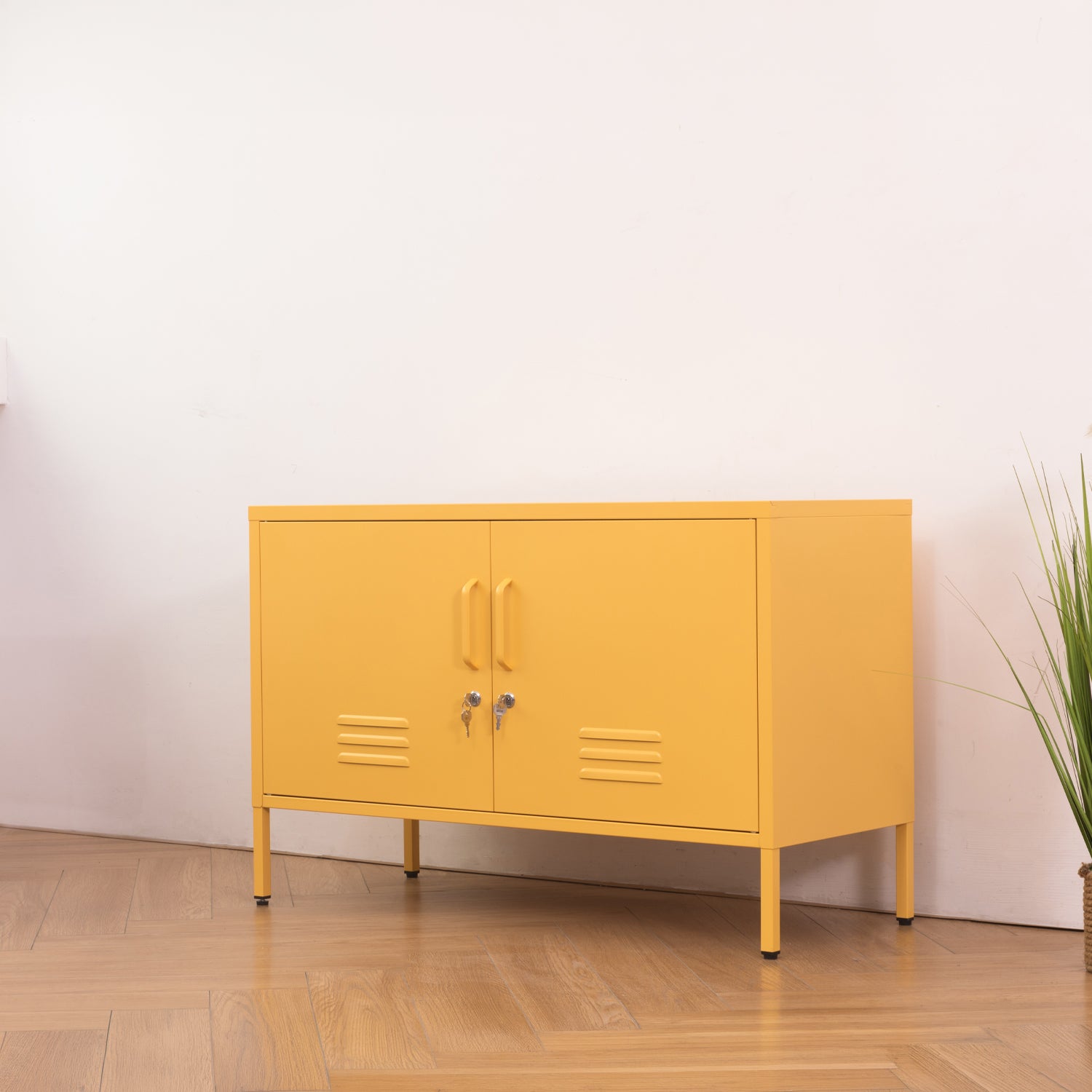 Design Republique Mila Low Locker Butter shown closed on an angle in a styled room setting with yellow metal finish, handles and lockable doors.