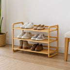 Home Co. Piper Bamboo 3 Tier Shoe Rack in natural bamboo styled in an entryway with assorted shoes arranged across the three shelves.