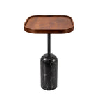 A modern accent side table featuring a rounded rectangular wooden top in a warm medium brown finish, supported by a sleek black metal stem and a cylindrical black marble base with subtle white veining, set against a solid white background.