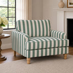 A classic green striped armchair is beautifully styled in a bright, timeless living room, bringing fresh colour, relaxed elegance and inviting comfort to the space.