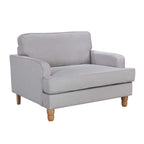 A generously sized neutral armchair combines timeless style, plush comfort and natural wood legs, making it a versatile statement piece for both classic and contemporary interiors.