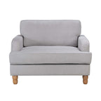 A generously sized neutral armchair combines timeless style, plush comfort and natural wood legs, making it a versatile statement piece for both classic and contemporary interiors.