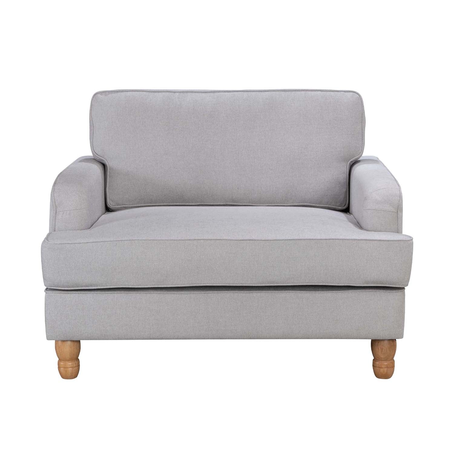 A generously sized neutral armchair combines timeless style, plush comfort and natural wood legs, making it a versatile statement piece for both classic and contemporary interiors.