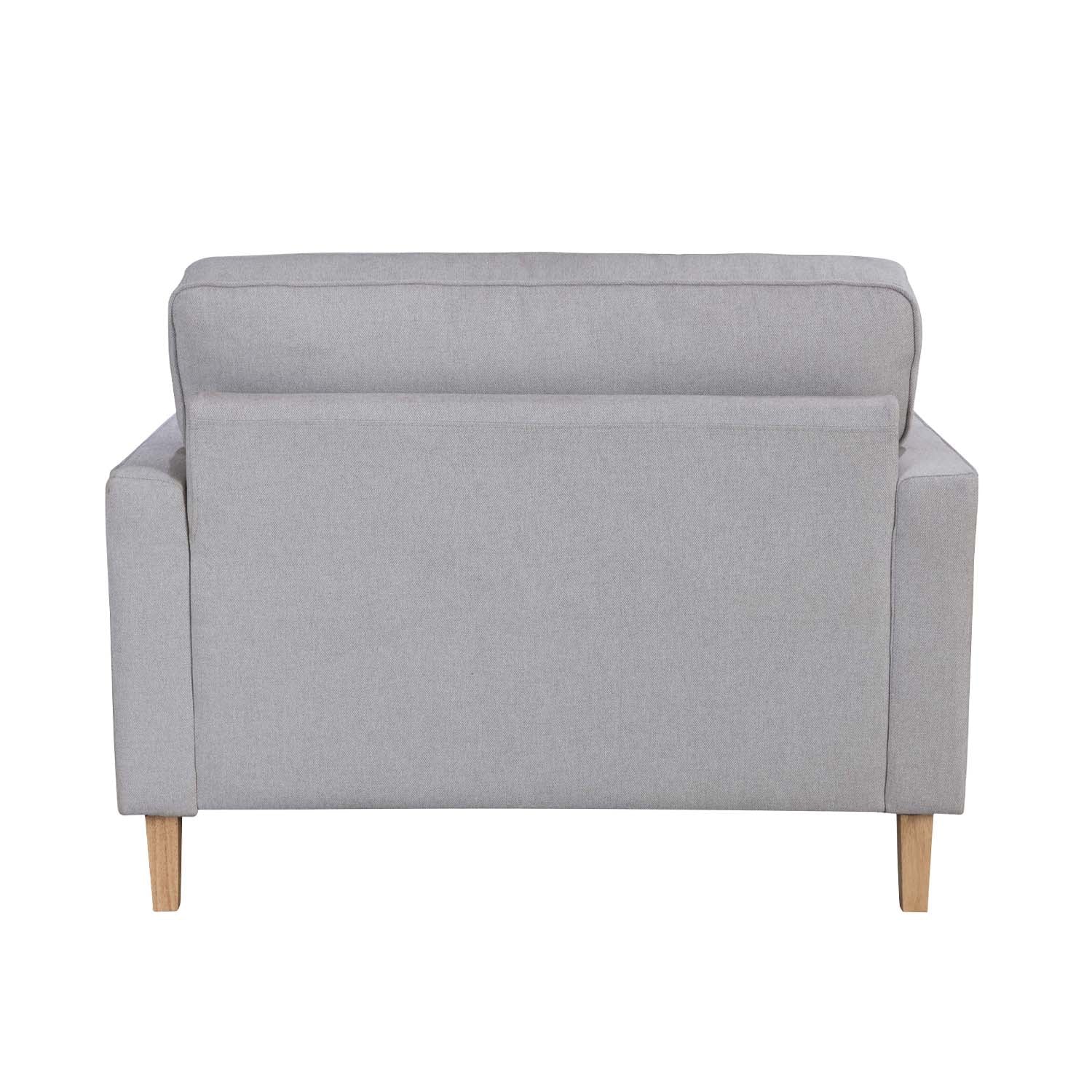 A generously sized neutral armchair combines timeless style, plush comfort and natural wood legs, making it a versatile statement piece for both classic and contemporary interiors.