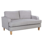 A contemporary natural two-seater sofa with clean lines, plush cushions and natural timber legs is shown against a white background, highlighting its timeless, versatile design.