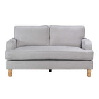 A contemporary natural two-seater sofa with clean lines, plush cushions and natural timber legs is shown against a white background, highlighting its timeless, versatile design.