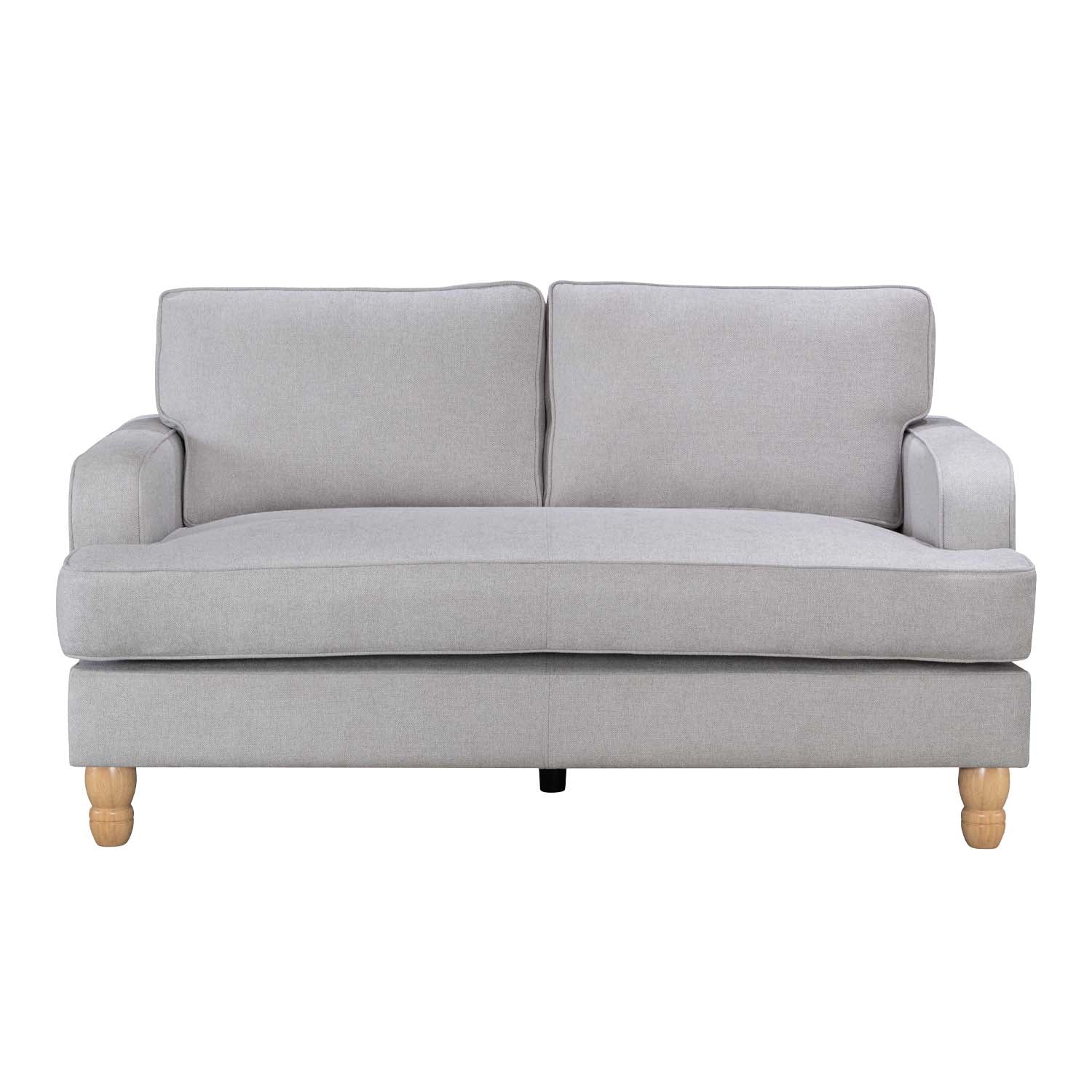 A contemporary natural two-seater sofa with clean lines, plush cushions and natural timber legs is shown against a white background, highlighting its timeless, versatile design.