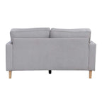 A contemporary natural two-seater sofa with clean lines, plush cushions and natural timber legs is shown against a white background, highlighting its timeless, versatile design.