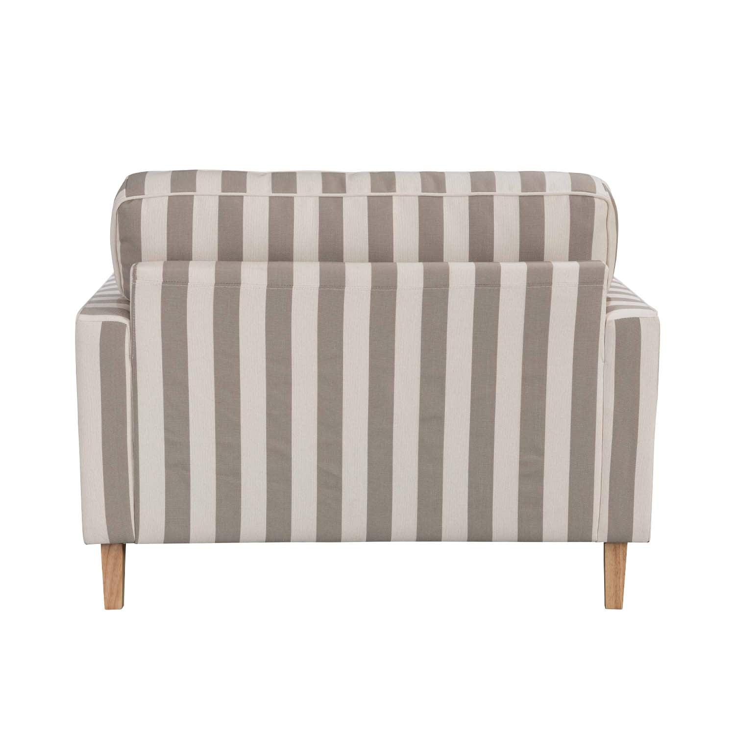 A generously sized striped armchair in soft neutral tones combines timeless style, plush comfort and natural wood legs to suit a range of classic and contemporary interiors.
