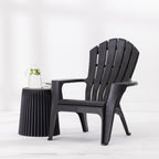 Black fluted side table paired with a matching outdoor chair, styled with a glass water jug and drinking glass.