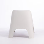 A modern moulded plastic chair in a cream colour.