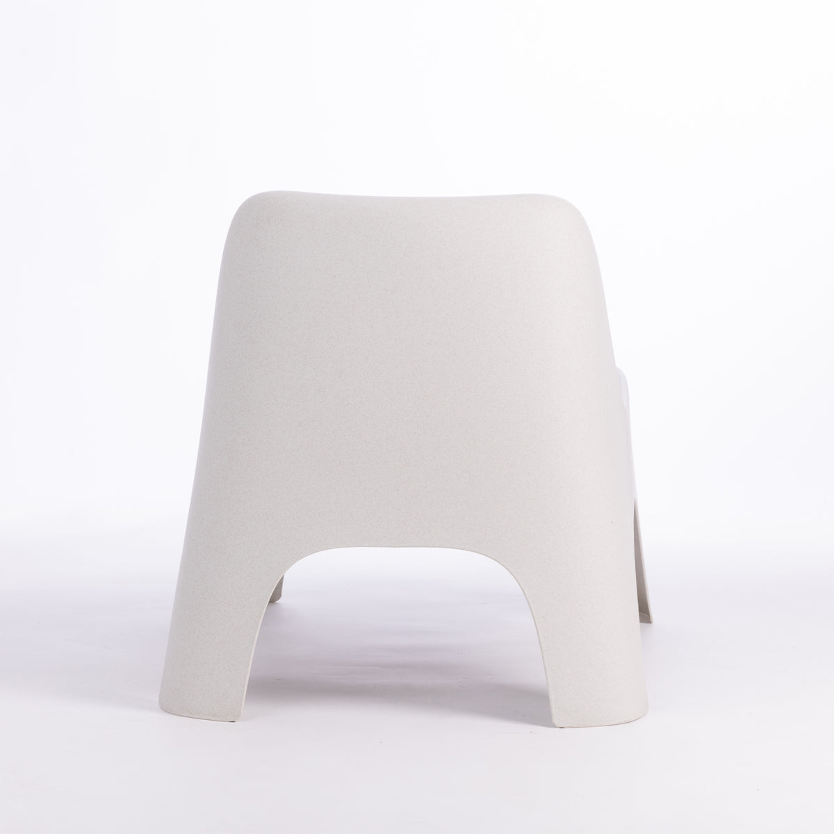 A modern moulded plastic chair in a cream colour.