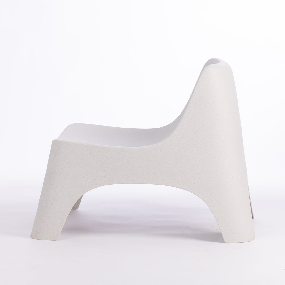 A modern moulded plastic chair in a cream colour.