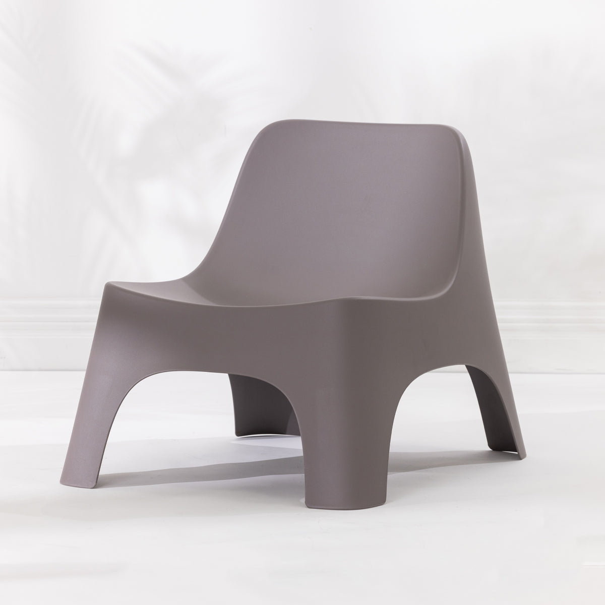 A modern moulded plastic chair in a mocha colour.