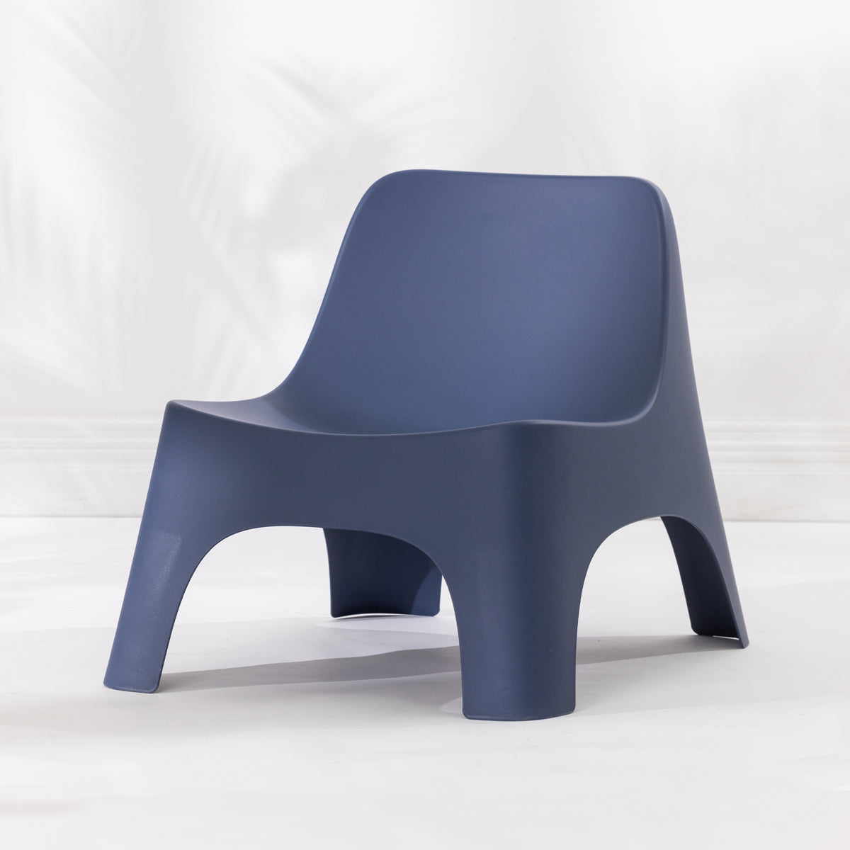 A modern moulded plastic chair in a navy blue colour.