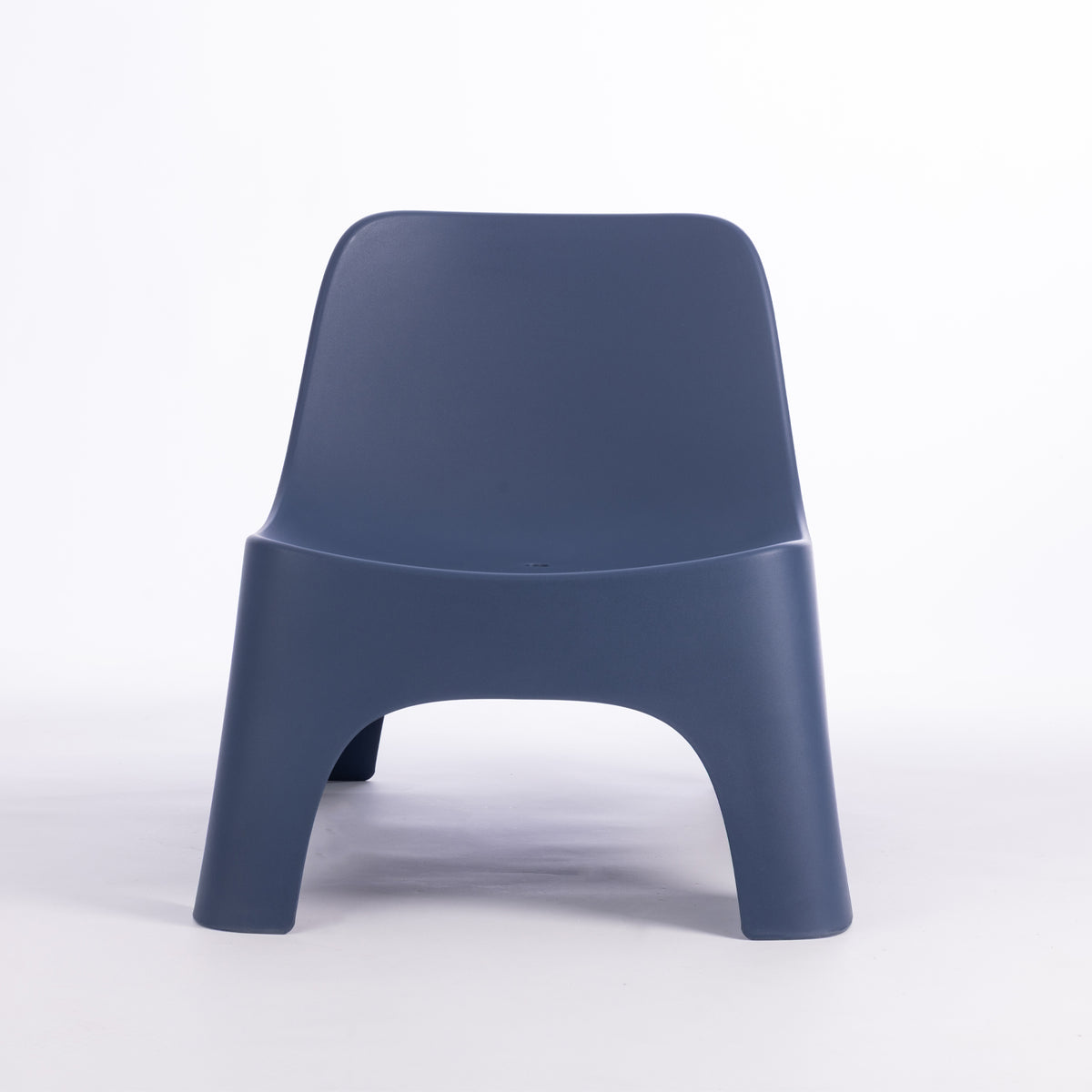 A modern moulded plastic chair in a navy blue colour.
