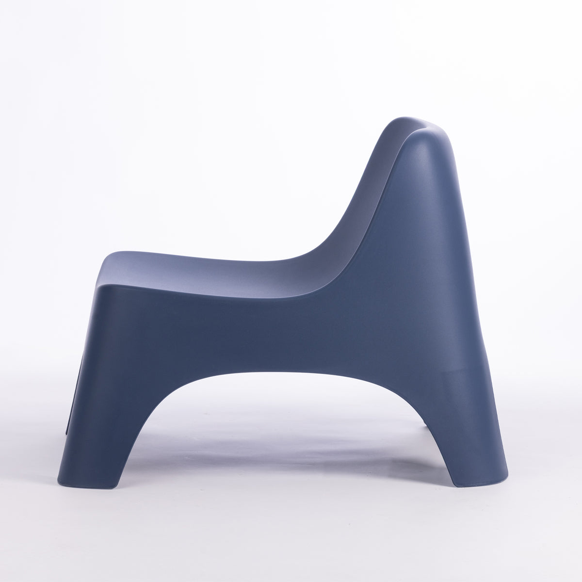 A modern moulded plastic chair in a navy blue colour.