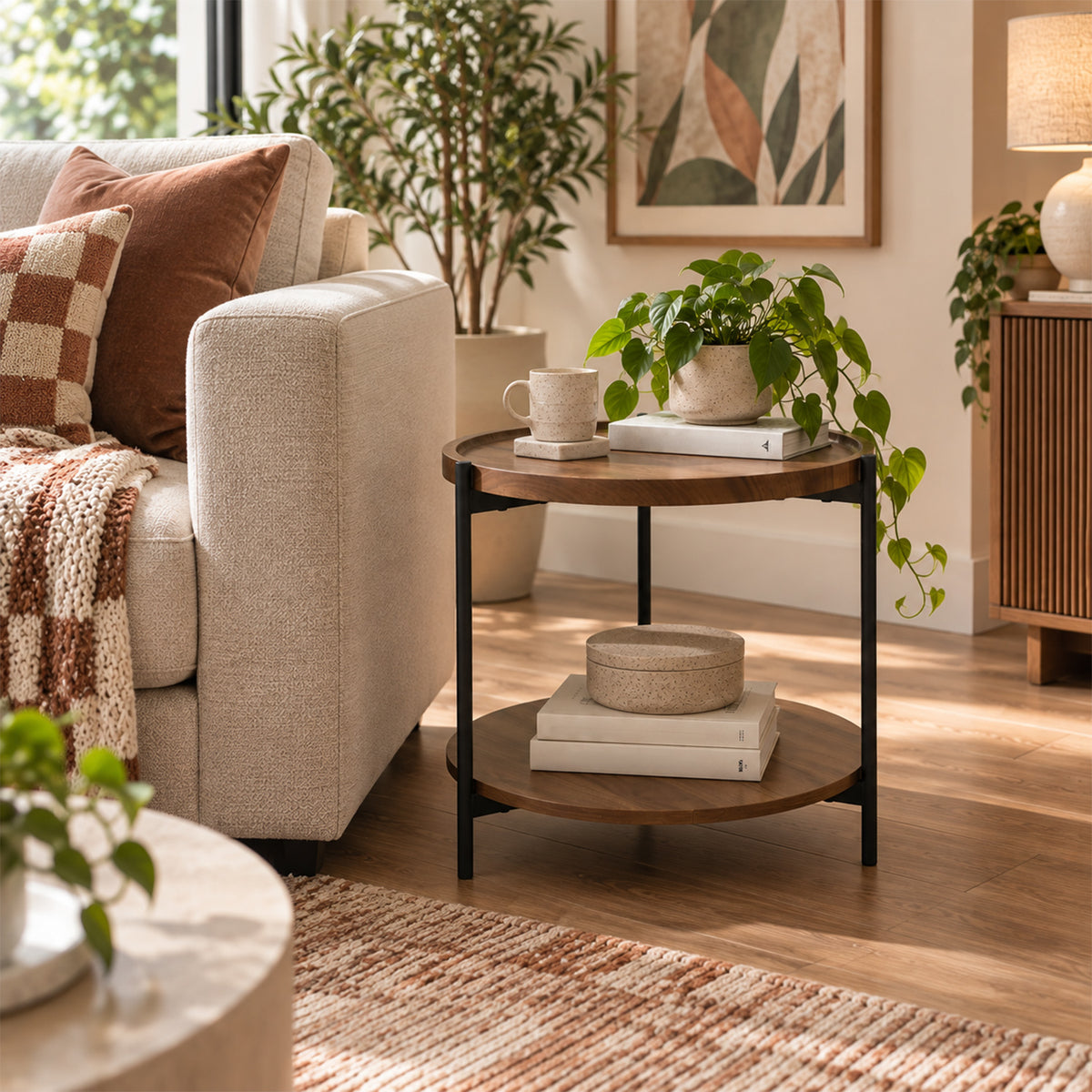 Design Plus Rio Side Table styled beside a cream sofa in a warm living room with books, decorative accessories and indoor plants.