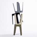 Four stools in black, stormy grey, olive & cream, stacked together on a clean white studio background.
