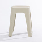 A cream stool on a clean white studio background.