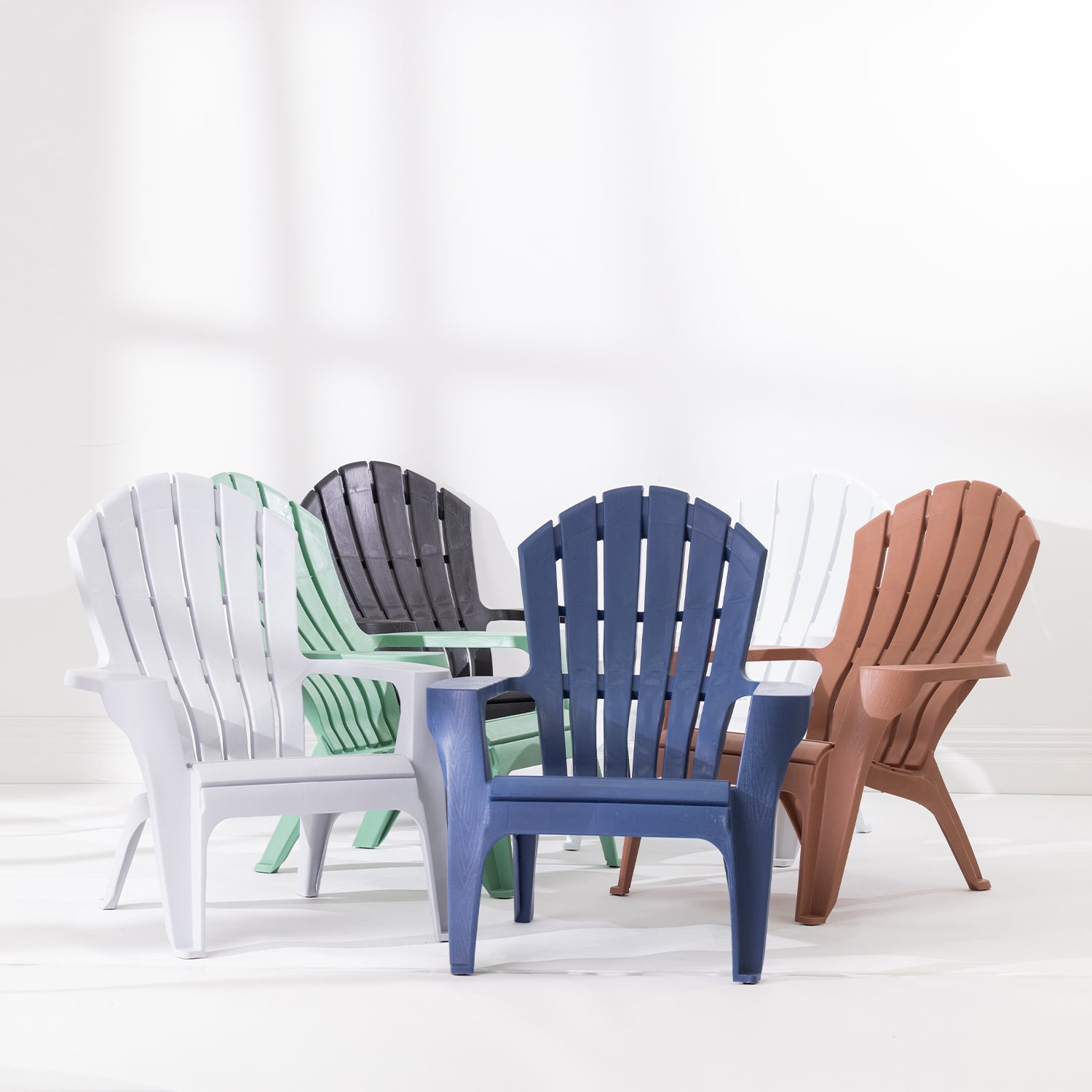 Group of Cape Cod chairs in Navy, Green, Grey, White, Tan and Black arranged together against a white studio background.