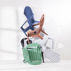 Group of Cape Cod chairs in Navy, Green, Grey, White, Tan and Black stacked together against a white studio background.