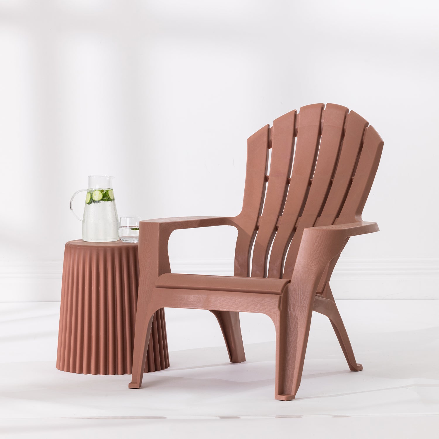 Tan Cape Cod chair styled beside a Tan side table with a glass jug and drinking glass against a bright white studio background.