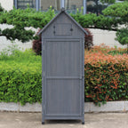A gray outdoor storage shed with a gabled roof and door.