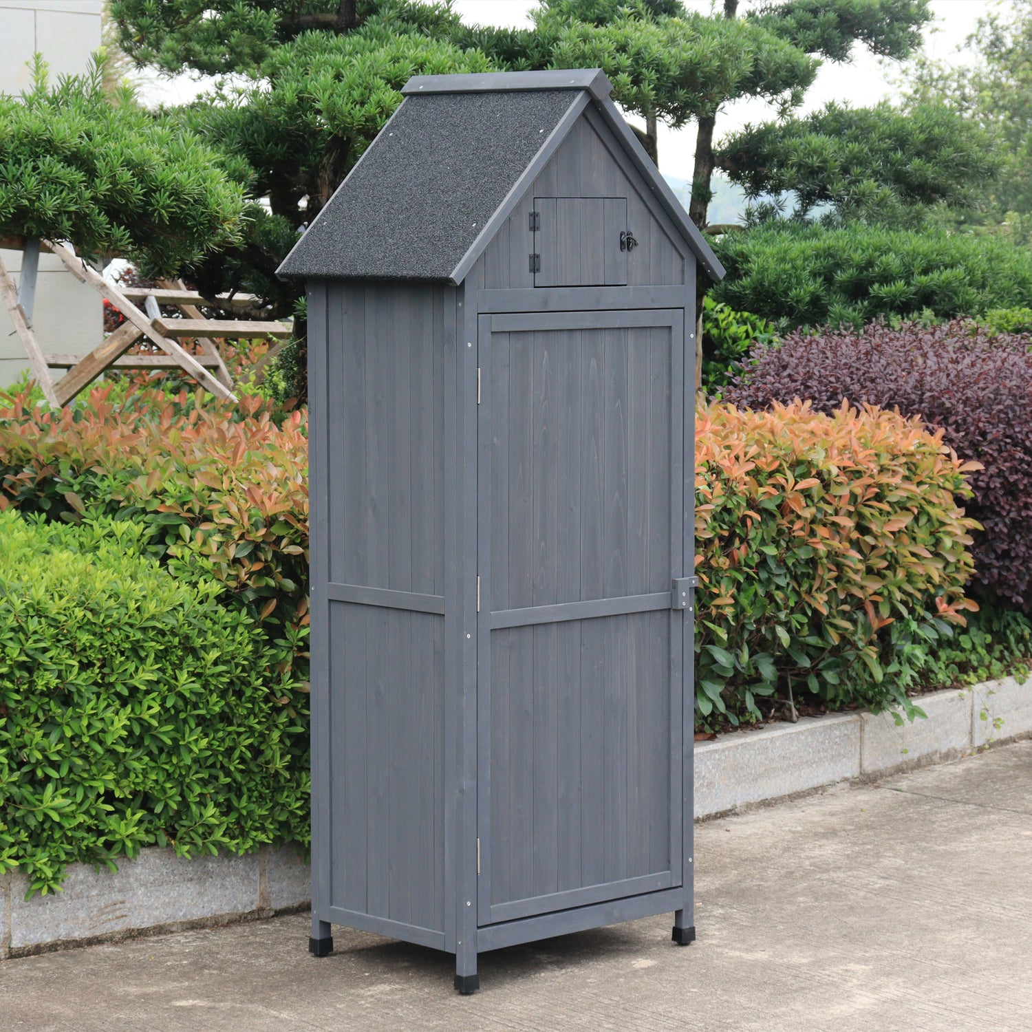 A gray outdoor storage shed with a gabled roof and door.