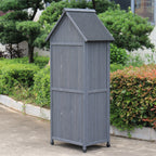The reverse of a grey outdoor storage shed with a gabled roof and door.