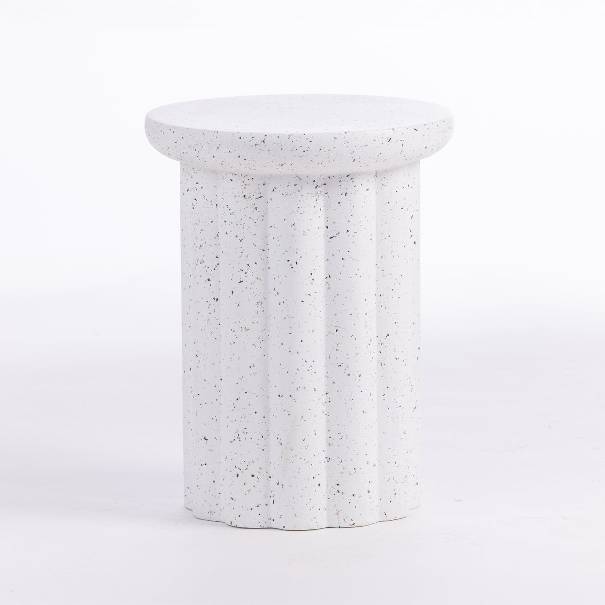 A white speckled side table with a fluted column base and a round top, shown on a seamless white background.