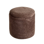 A round, cylindrical upholstered ottoman or pouf in a textured brown fabric, shown against a plain white background.