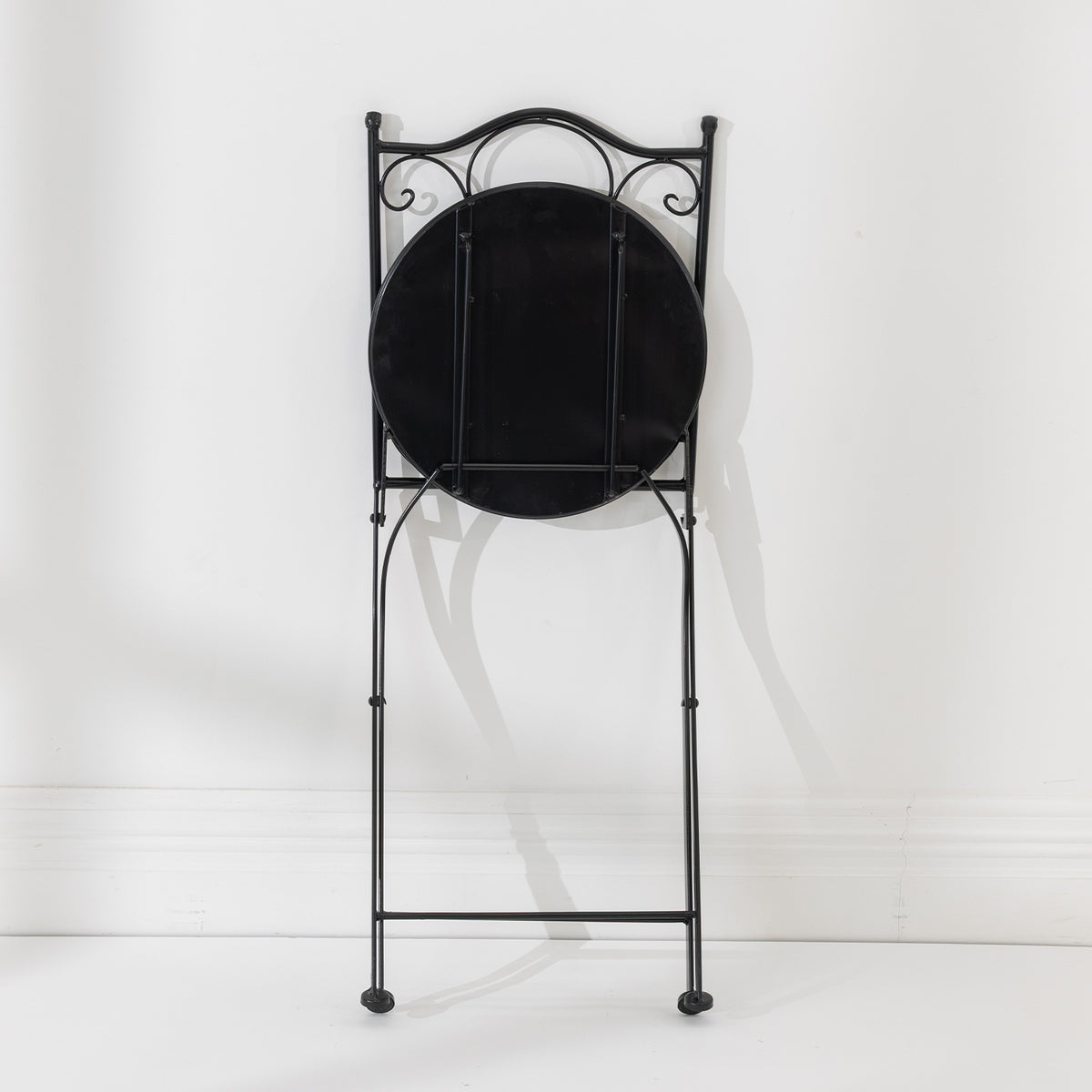 Rear view of the folded Outsidings Blue Tile Mosaic Chair showing the black metal frame and underside of the mosaic seat.