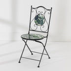 Outsidings Green Leaves Mosaic Chair with black metal frame, decorative scrollwork and green leaf mosaic seat and backrest.