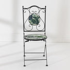 Front view of the Outsidings Green Leaves Mosaic Chair with green leaf mosaic detailing and decorative black metal frame.