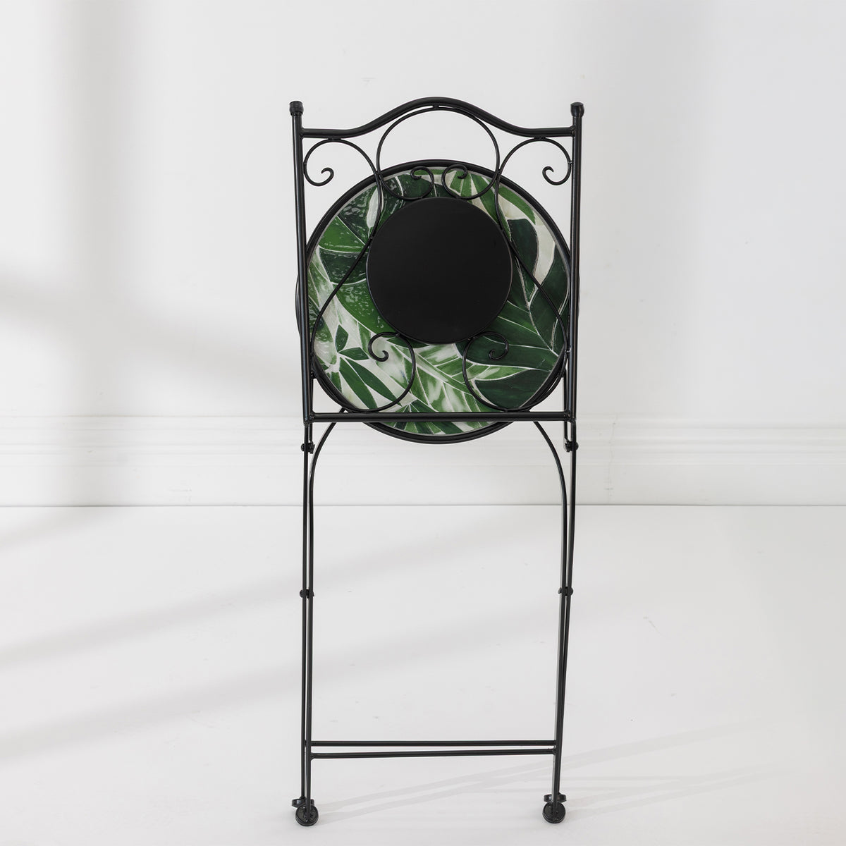 Rear view of the folded Outsidings Green Leaves Mosaic Chair showing the black metal frame and mosaic panels.