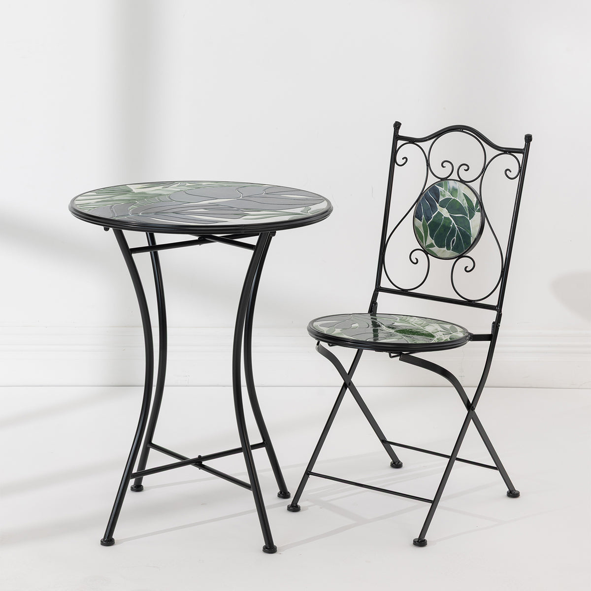 Outsidings Green Leaves Mosaic Chair and matching round table featuring green leaf mosaic designs and black metal frames.