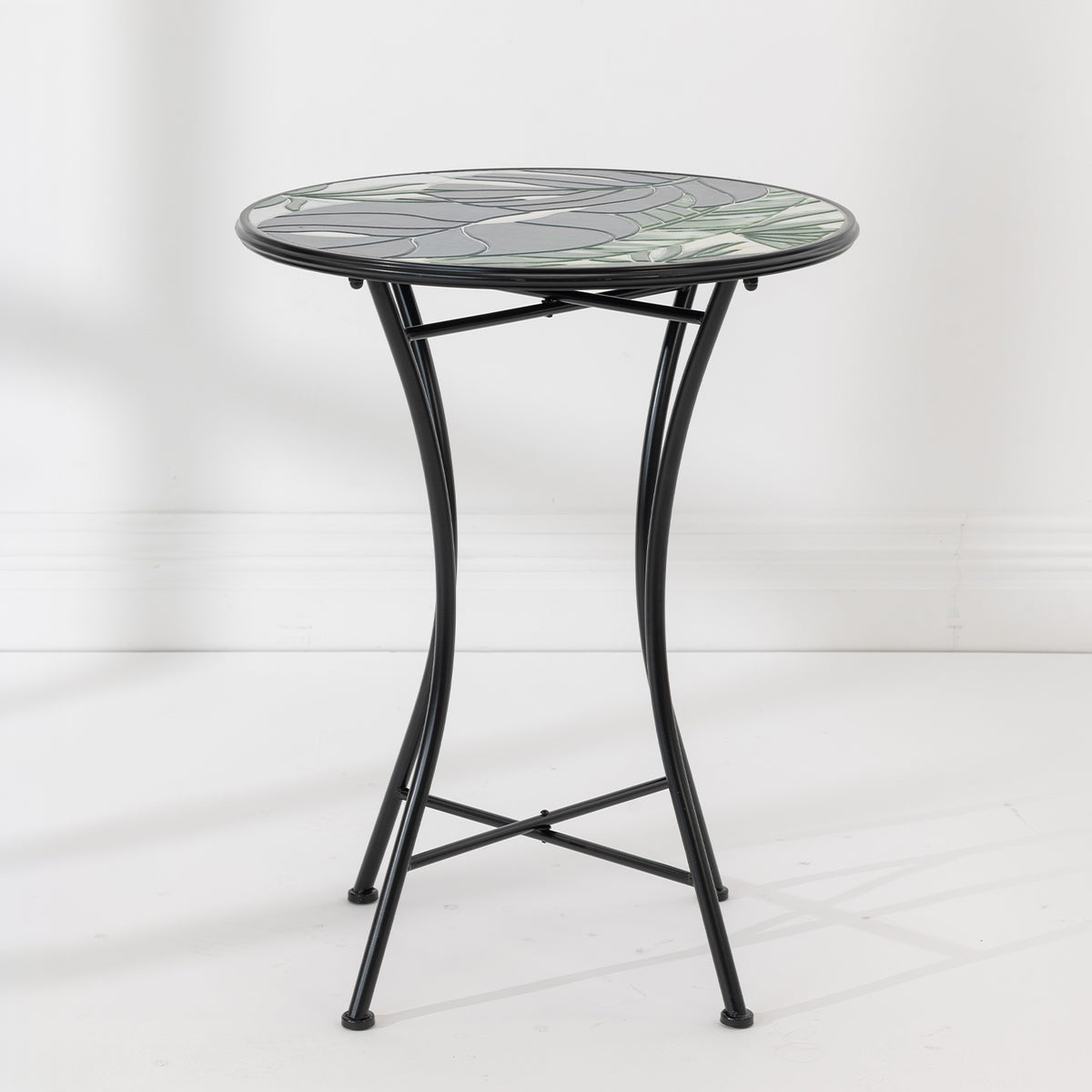 Outsidings Green Leaves Mosaic Table with round green leaf mosaic top and curved black metal frame.